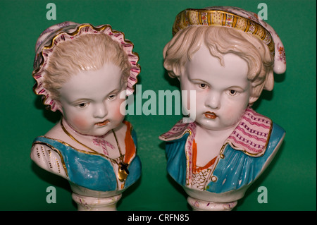 PAIR OF ANTIQUE BRITISH  PORCELAIN BUSTS OF CHILDREN BY BEVINGTON Stock Photo