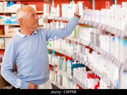 Customer browsing on drugstore shelves Stock Photo