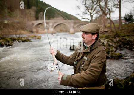 Man fishing for salmon in river Stock Photo