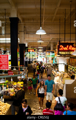 A couple smiling and walking in an indoor market in downtown Los Angeles that sells fresh produce. Stock Photo