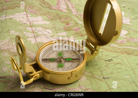 Lensatic sighting compass on a topographic map Stock Photo