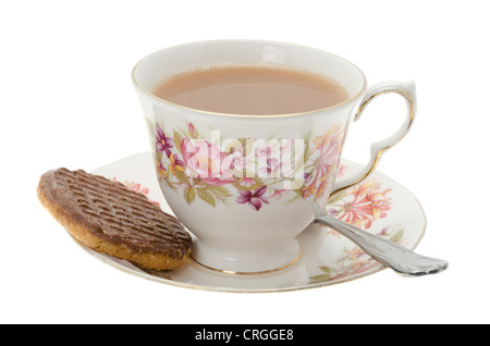 Bone china cup and saucer containing hot tea with a chocolate biscuit Stock Photo
