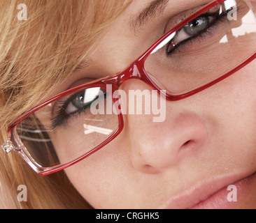 face of a young woman wearing red spectacles Stock Photo