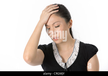 Asian woman holding head whilst having a headache. isolated on white background Stock Photo