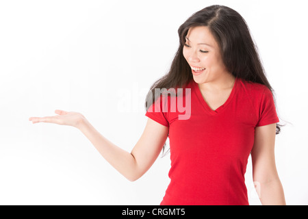 Happy Asian woman holding out her hand to show your message. Isolated on white background. Stock Photo