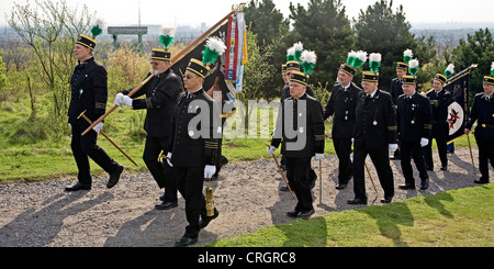 pit men in traditional clothing at stockpile Haniel on a crossroad, Germany, North Rhine-Westphalia, Bottrop Stock Photo