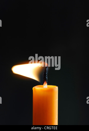 burning candle flame in the wind Stock Photo