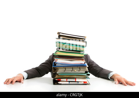 tired Businessman hiding behind paperwork Stock Photo