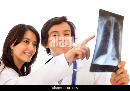 two young doctors looking at an xray, the woman is pointing at the image Stock Photo