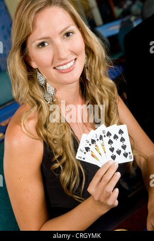 woman gambling at the casino showing a royal flush Stock Photo