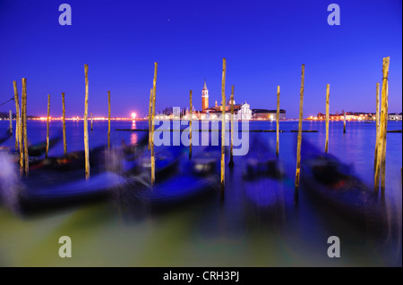 Gondolas moored in front of the Basilica of San Giorgio Maggiore at nightime, Venice, Veneto, Italy Stock Photo