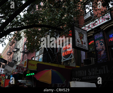Sidewalk tree, red neon 'Psychic Readings', 'Andromeda Tattoo Body Piercing' studio, 33 St Mark's Place, East Village, New York Stock Photo