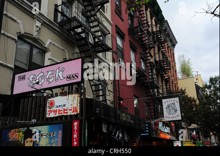 Ornate tenements with 'Sock Man' clothes shop, 'Addiction NYC' tattoo studio signs, St Mark's Place, East Village, New York Stock Photo