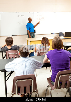 Handsome african-american math teacher solving a problem for his class.  Stock Photo