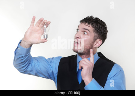 handsome man holding a light bulb in his hand  Stock Photo
