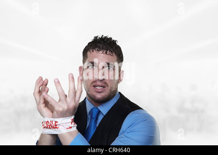 handsome man with his wrist taped up with fragile tape so he cant do any work and in need od some help Stock Photo