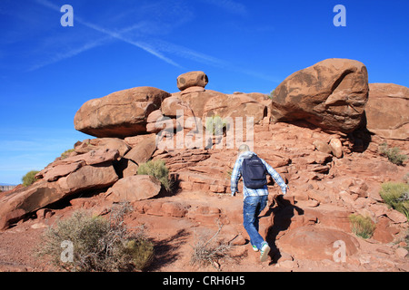 Tourist hiking up rocks near the Grand canyon Stock Photo