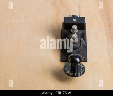 An antique telegraph key on a wooden desk Stock Photo