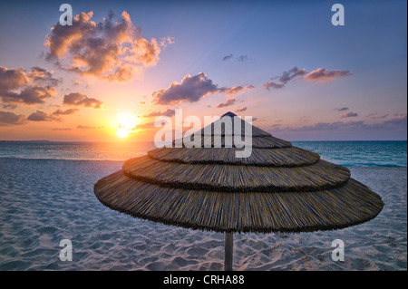 Reed umbrella and sunset. Grace Bay. Providenciales. Turks and Caicos. Stock Photo