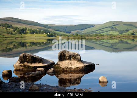 Water Polished Rocks, Placid lake Semerwater natural lake, and views to Raydale, Wensleydale, North Yorkshire Dales National park, Richmondshire, UK Stock Photo