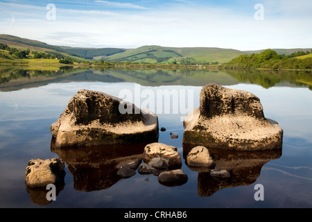 Water Polished Rocks, Placid lake Semerwater natural lake, and views to Raydale, Wensleydale, North Yorkshire Dales National park, Richmondshire, UK Stock Photo