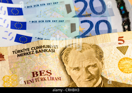 Turkish 5 Lira bank note against a number of Euro notes Stock Photo