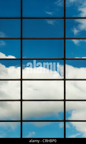 Blue sky and clouds reflected in Office block glass windows. London