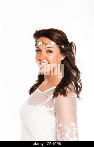 An eighteen year old brunette woman in a white sun dress with a