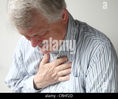 a senior man suffering from bad pain in his chest Stock Photo