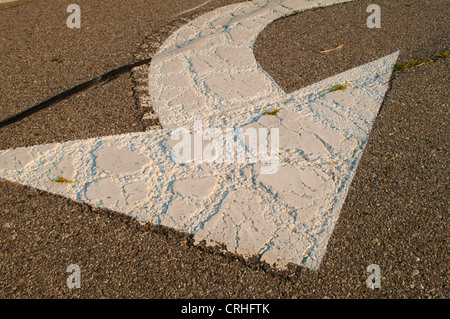 white curved painted arrow on street or road Stock Photo