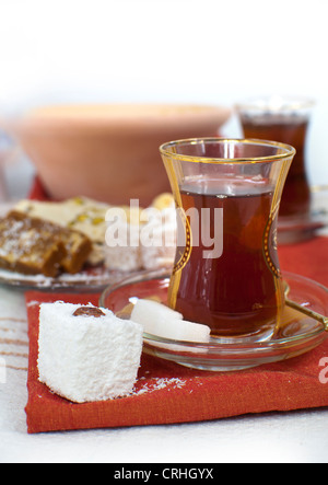 Traditional turkish chai in glasses, served with two sugar cubes and turkish delight Stock Photo