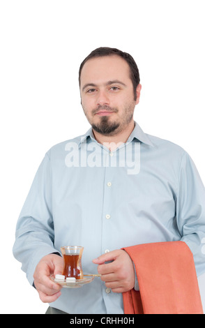Young man serving traditional turkish chai in glass Stock Photo