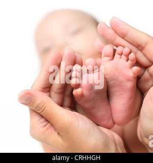 Close-up of newborn baby's feet in mammy's hands Stock Photo