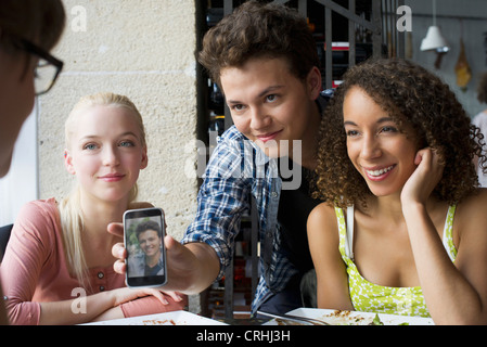 Young man showing friends photophone Stock Photo