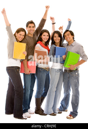 group of happy students standing together with their notebooks, cheering with outstretched arms Stock Photo