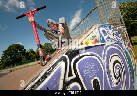 scooter rider in urban skate park, eaton park, norwich, norfolk, england Stock Photo