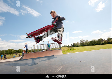 scooter rider in urban skate park, eaton park, norwich, norfolk, england Stock Photo