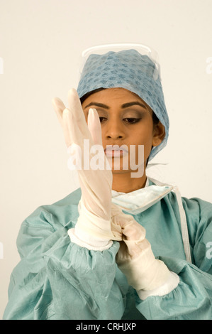 A surgeon putting on surgical gloves. Stock Photo