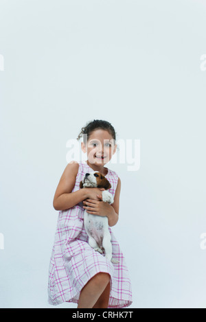 Girl holding beagle puppy Stock Photo