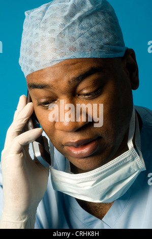 doctor on the phone in his surgical clothing Stock Photo