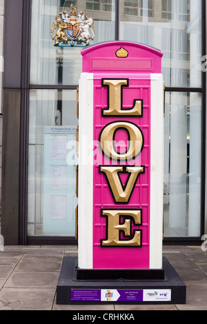 Pink telephone box adorned with the Union flag diamond dust and the message Long  Live Life  Love for the BT ArtBox project Stock Photo