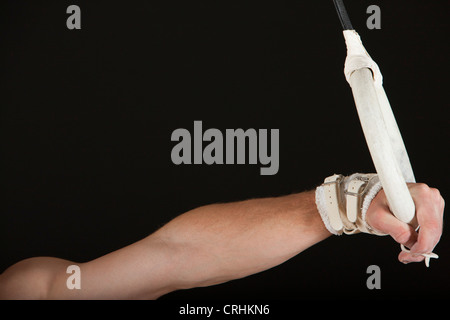 Male gymnast's hand holding onto gymnastics ring Stock Photo