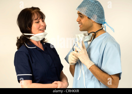 A surgeon and nurse discuss work. Stock Photo