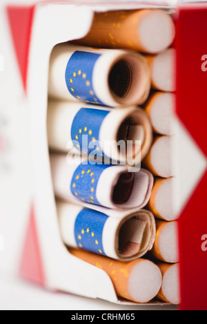 Cigarette pack containing rolled euros Stock Photo