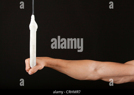 Male gymnast's hand holding onto gymnastics ring Stock Photo