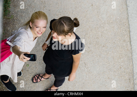Young women posing for cell phone picture Stock Photo