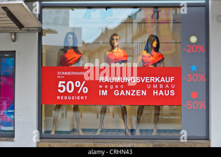 3 Mannequins in Shop Window Clearance Sale Promotion 50% discount for closing out sale - Heilbronn Germany Stock Photo