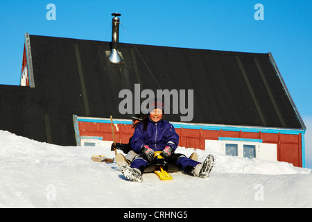 children playing in the snow, Greenland, Ostgroenland, Tunu, Kalaallit Nunaat, Scoresbysund, Kangertittivag, Ittoqqortoormiit Stock Photo