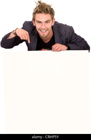 young man pointing at a blank sign Stock Photo