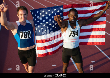 Running teammates embracing after race Stock Photo